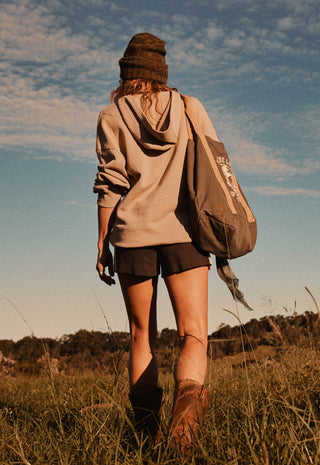  wearing a beige pullover hoodie