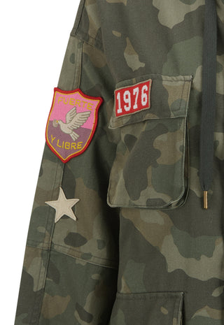 close-up-of-a-camouflage-jacket-with-a-pink-and-yellow-patch-a-red-1976-patch-and-a-white-star-patch-on-the-sleeve